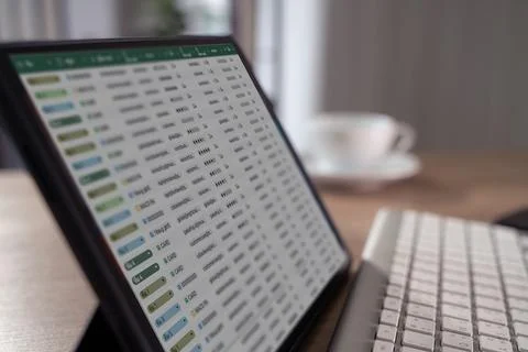 Spreadsheet document data tablet keyboard rows columns finance accounting a.. Foto stock