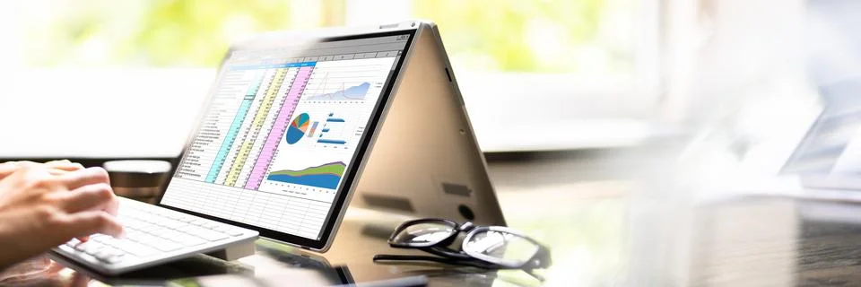 Spreadsheet Graphs On Laptop Screen. Working Stock Photos