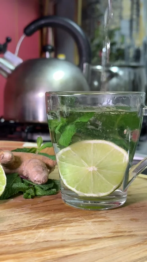 Sprig of mint in a transparent mug. Mint tea in the sun. Background, texture Video stock 321821561