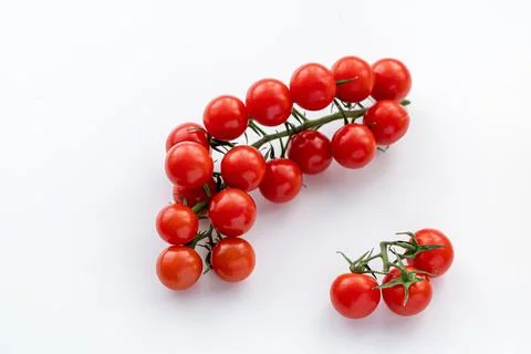 Sprig of red cherry tomatoes on the table. Stock Photos