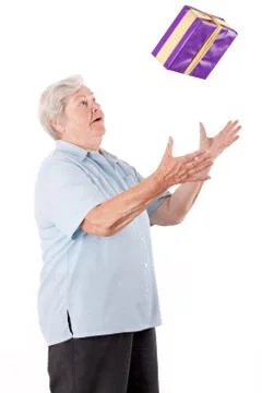 Sprightly senior catches or throws  gift 스톡 사진