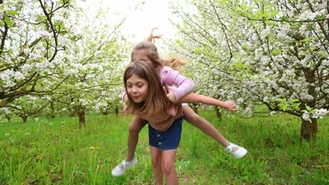 Spring Adventures: Playing in the Blooming Garden Stock Footage 301586910