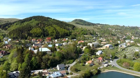 Spring aerial panorama of mining lakes and town of Stiavnicke Bane, Slovakia Stock Footage 129974554
