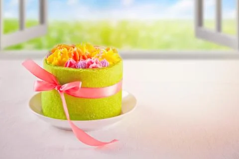 Spring and Easter concept. Small green cake with butter cream flowers near a  Photos
