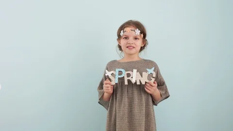 Spring and welcome. Spring concept. Children on a pale blue mint background are Stock Footage 101464404