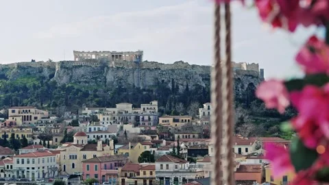 Spring in Athens, cinematic view of bloomed flowers and .Acropolis at backgro Video stock 310335010