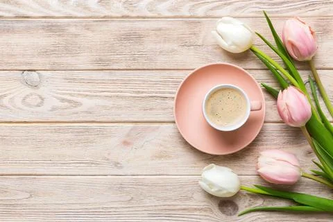 Spring background with flowers, a cup of coffee and a bouquet of pink and whi Stock Photos