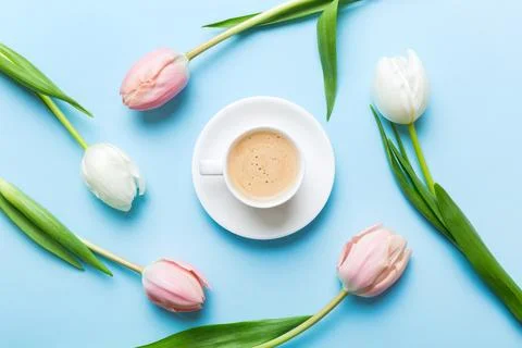 Spring background with flowers, a cup of coffee and a bouquet of pink and whi Stock Photos