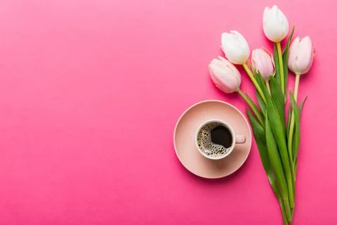 Spring background with flowers, a cup of coffee and a bouquet of pink and w.. Stock Photos
