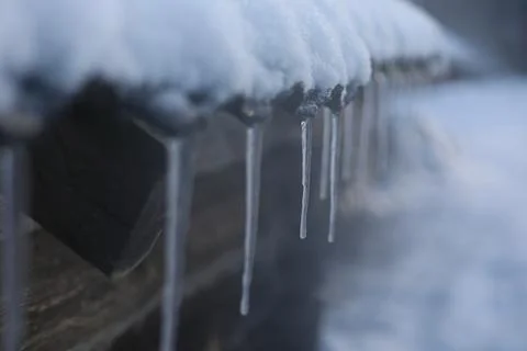 Spring background with icicles melting in the sun. Icicles close-up. Snow Stock Photos