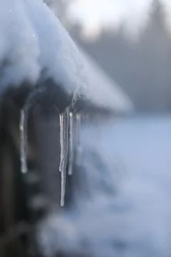 Spring background with icicles melting in the sun. Icicles close-up. Snow Stock Photos