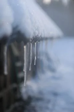 Spring background with icicles melting in the sun. Icicles close-up. Snow Stock Photos