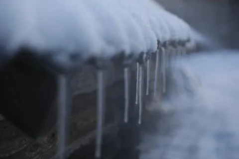 Spring background with icicles melting in the sun. Icicles close-up. Snow Stock Photos