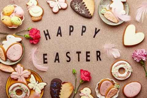 Spring background with text Happy Easter. Aesthetic pastel spring Easter cookies Stock Photos