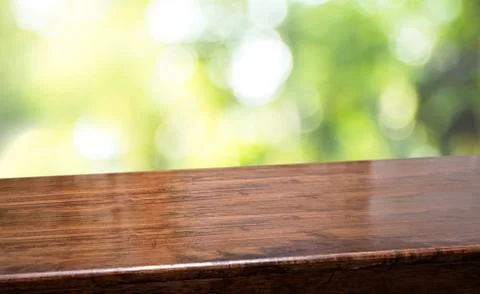 Spring background.Empty diagonal brown wooden table with blur tree in garden  Stock Photos