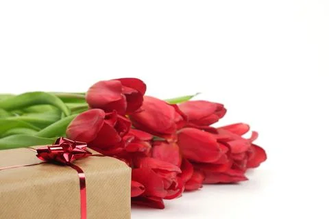 Spring banner composition from gift box, covered by brown craft paper, tied b Stock-Fotos