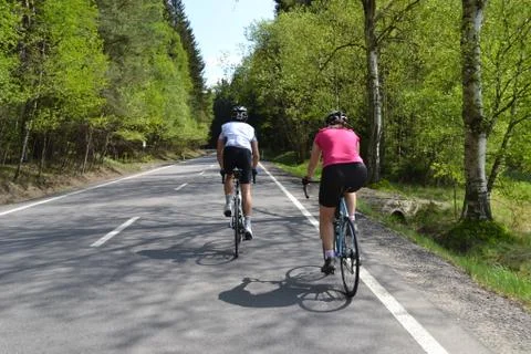 Spring bike riding through tree avenue Foto stock