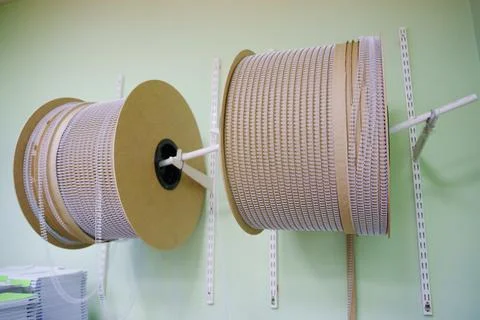 A spring for binding calendars or notebooks in a professional printing house. Stock Photos