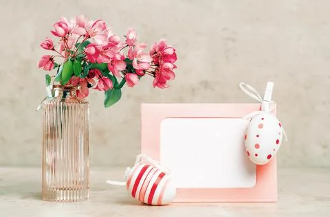 Spring blooming tree branches and easter egg in a vase on pastel background Stock Photos