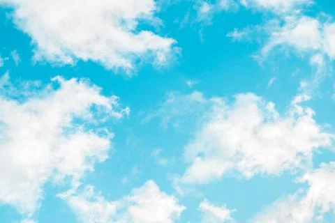 Spring blue sky with fluffy clouds moved by the wind Stock Photos