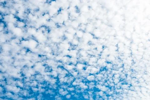 Spring blue sky with fluffy clouds moved by the wind Stock Photos