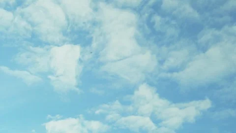 Spring blue sky flying white fluffy clouds in sunlight air plane window view, ti Video stock 332921338