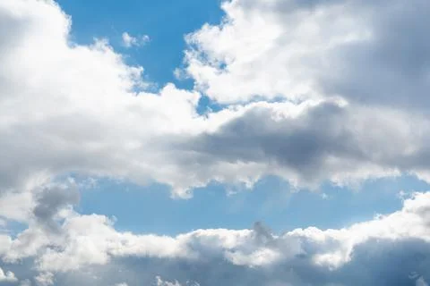 Spring blue sky with white clouds and skylights on a bright sunny day Stock Photos