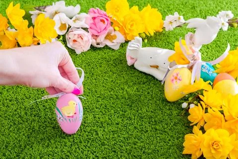 Spring bouquet with colorful easter eggs on a grass background. Happy Easter Stock Photos