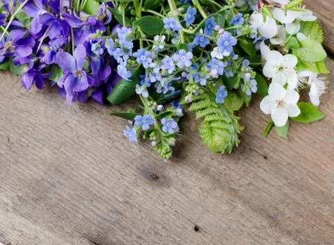 Spring bouquet with violets and forget-me-not flowers on a wooden background Stock Photos