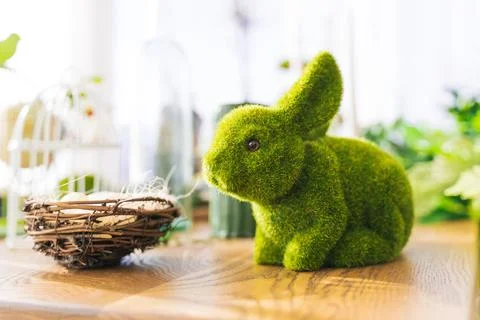 Spring bunny from green grass on the table. Easter holiday Stock Photos
