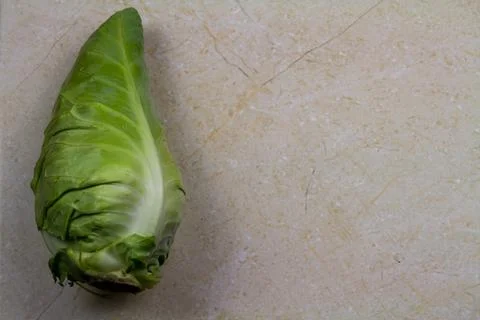 Spring cabbage single, with a marble background. Stock Photos