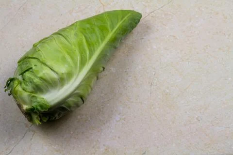 Spring cabbage single, with a marble background. Stock Photos