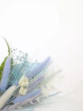 Spring card. Topper on the cake. Blue leaves of Palma and dry flowers. Flat lay Stock Photos