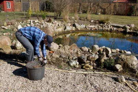 Spring cleaning at the pond Stock Photos