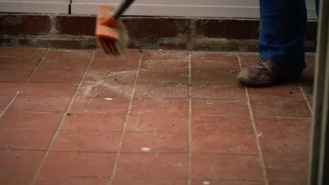 Spring cleaning sweeping tiled floor room with a broom Stock Footage 310942519