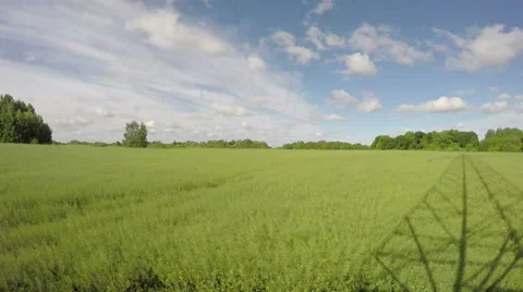 Spring clouds motion in farmland rapeseed field. Timelapse 4K Stock Footage 54683256