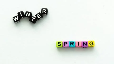 Spring coming and changing winter. Spring concept. Colorful letter beads on Stock Photos