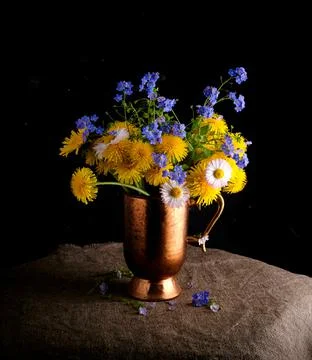 Spring composition: a bouquet of forget-me-nots and dandelions Stock Photos