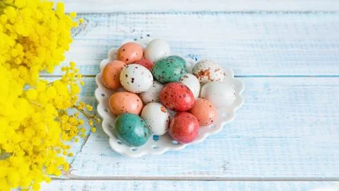 Spring composition of Easter colored candies in the form of eggs on a white p Stock Photos