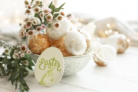 Spring composition with Easter eggs and flowers on a blurred background. Stock Photos