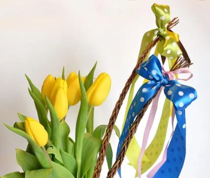 Spring composition: two easter whips with bunch of yellow tulips Stock Photos