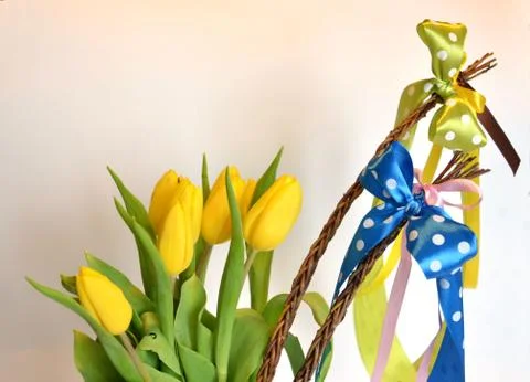 Spring composition: two easter whips with bunch of yellow tulips Stock Photos