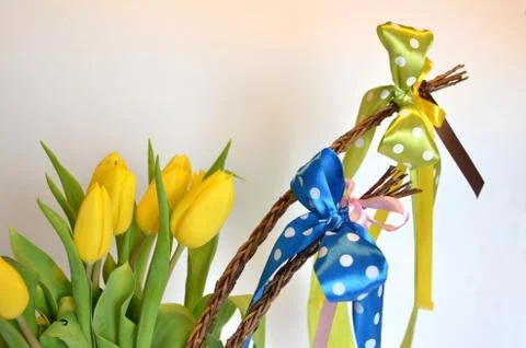 Spring composition: two easter whips with bunch of yellow tulips Stock Photos
