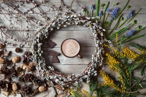 Spring composition with willow twigs wreath and hot chocolate Stock Photos
