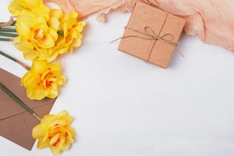 Spring composition with yellow flowers, giftbox and other objects Stock Photos