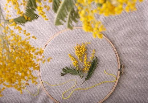 Spring concept of creativity and needlework. As if embroidered with yellow th Stock Photos