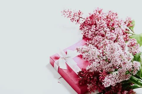 Spring concept. Lilac branches and gift box Stock Photos