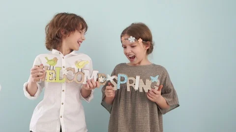 Spring concept. Studio portrait of cute school children with wooden signs Stock Footage 101439757
