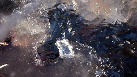 Spring creek under gray ice. Stock Footage 125205316