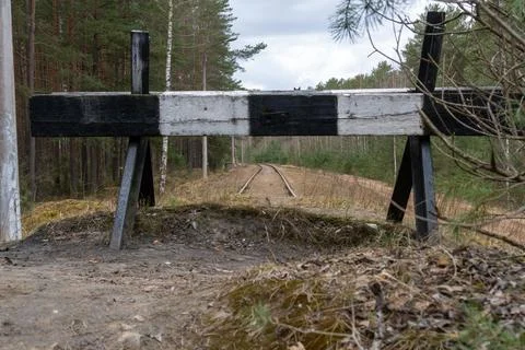 Spring day view of the train tracks winding between a small and a track end b Stock Photos